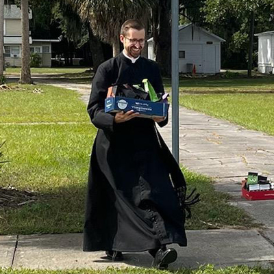 Father Matthew with candy for the school